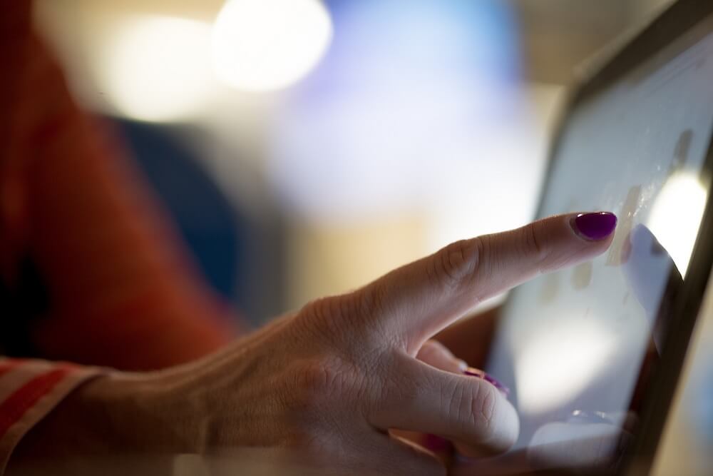 woman's finger touching touchscreen